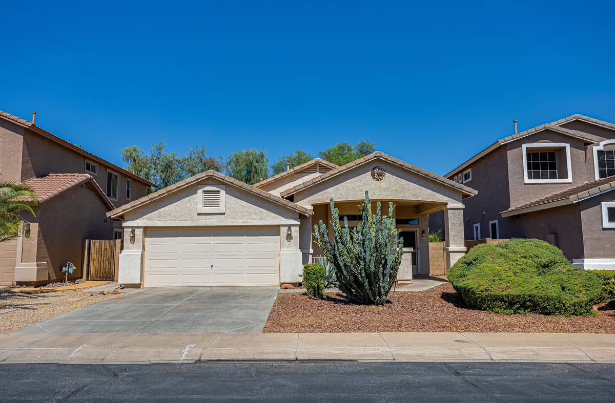 The image displays a welcoming front porch framed by cactus plants and landscaped bushes. The area exudes a sense of warmth and community, offering a comfortable spot for outdoor relaxation and social gatherings. The landscaping ties the home to the surrounding desert environment, reinforcing a sense of place within Rancho El Dorado.