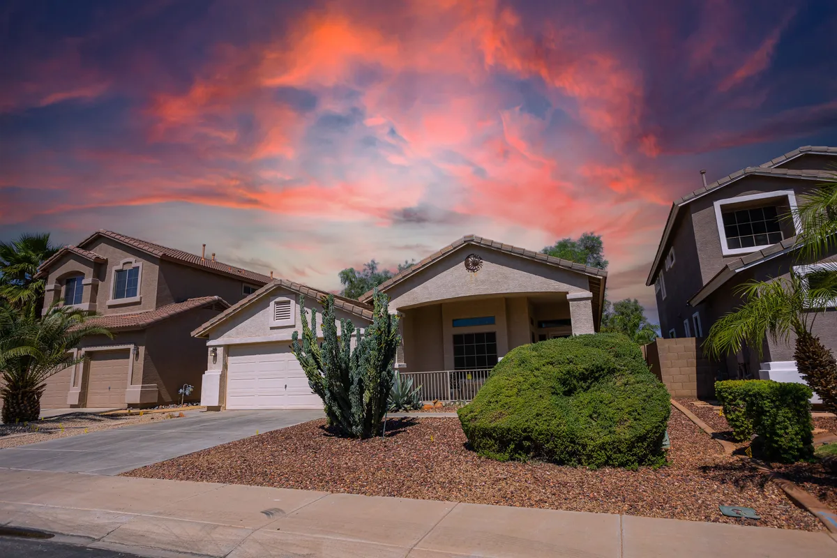 A welcoming front porch with cacti, attractive landscaping, and a wide desert sky. The setting is perfect for gatherings, relaxation, and enjoying the scenic environment after a day on the golf course.